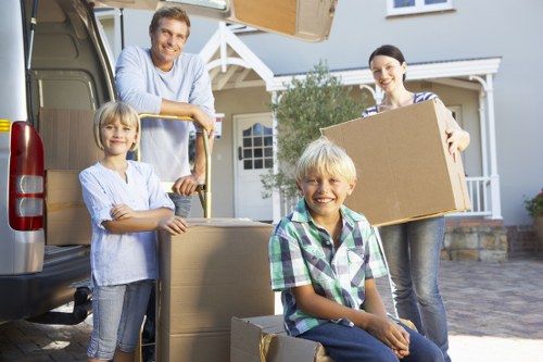 Removal team handling household items for transport